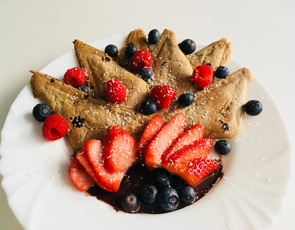 Vegan protein waffles with berries and chocolate sauce