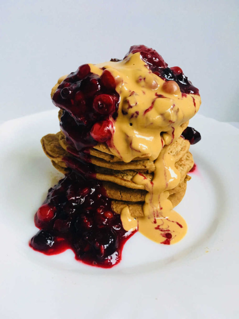 Vegan protein pancake with berries and peanut butter for Valentine day breakfast in bed
